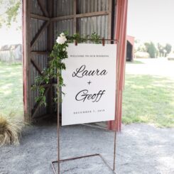 sign board hanging off frame with flower decorations