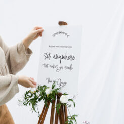 canvas sign on wooden easel in gardens